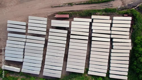 top down aerial of parking lot with many semi trucks and trailers - reefers, dry vans. 
Parked in a grid pattern. photo