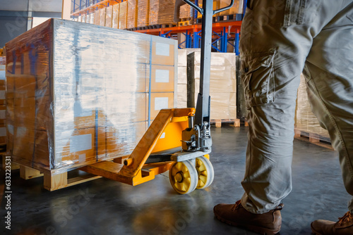 Workers Unloading Package Boxes on Pallets in Storage Warehouse.  Forklift Pallet Jack Loader. Supplies Shipment, Supply Chain Goods, Distribution Warehouse Shipping.