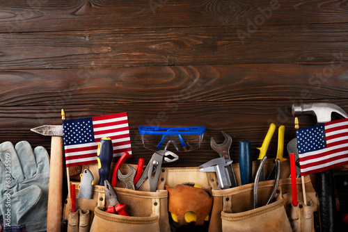 Labor day banner mockup of tools toolbelt and us flag on wooden background