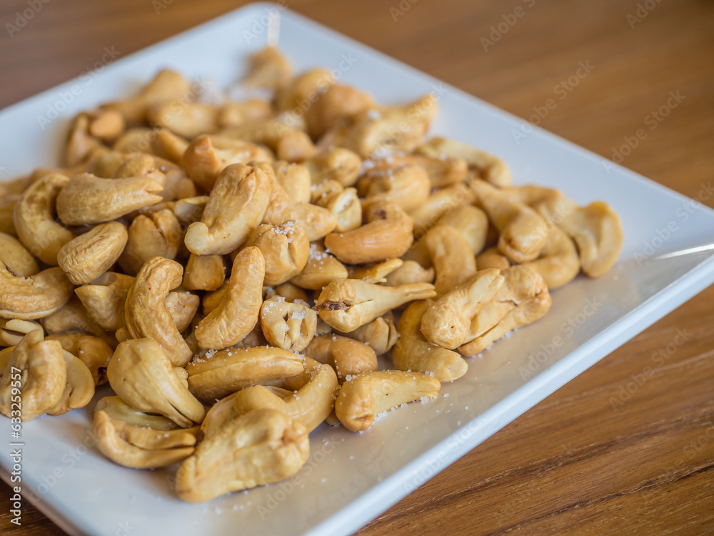 cashew nuts in a square white dish cashew nuts in a square white dish