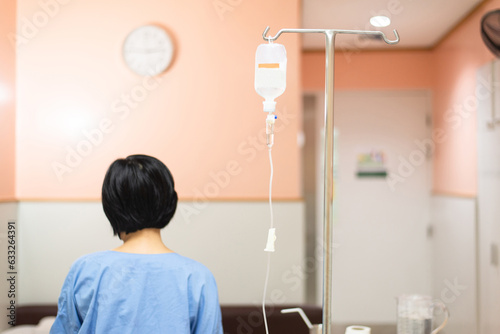 Picture of drop saline solution with blured petient in a hospital