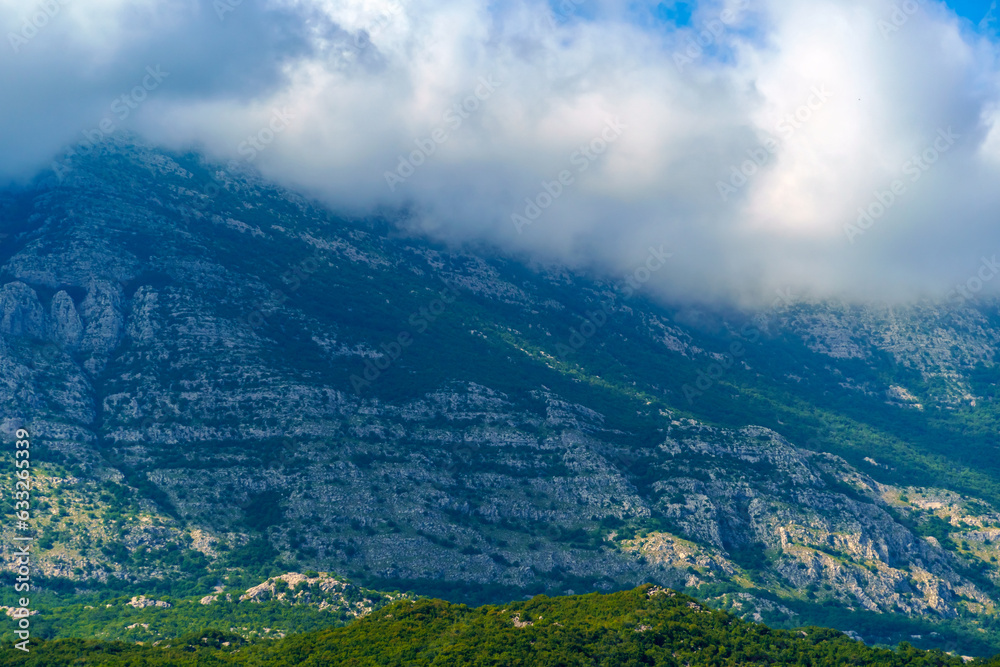 Fototapeta premium beautiful mountains and cloudy sky, summer landscape, clouds, forest on the hillsides