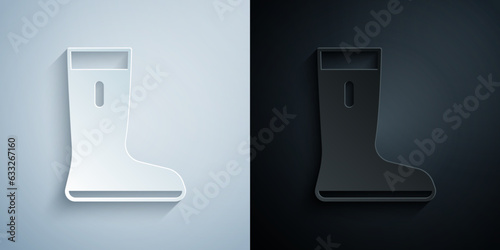 Paper cut Waterproof rubber boot icon isolated on grey and black background. Gumboots for rainy weather, fishing, gardening. Paper art style. Vector