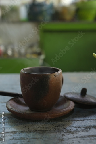A pottery cup on the table. Cangkir gerabah photo