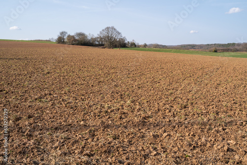 Plowed farmland with brown soil on a sunny day in spring