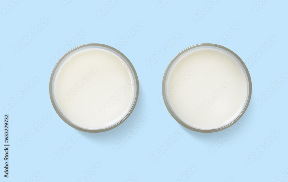 Milk in a glass top view on a blue background Milk in a glass top view on a blue background