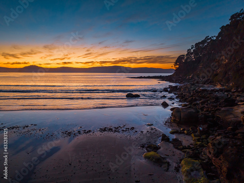 Pretty sunrise at the seaside with high cloud and low tide