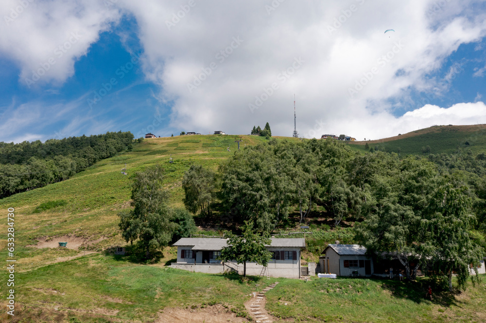 Drone photography of a mountain above Locarno, Cardada area. One can see Cimenta, its antenna meadows and woods. Summer season. Drone photography of a mountain above Locarno, Cardada area. One can see Cimenta, its antenna meadows and woods. Summer season.