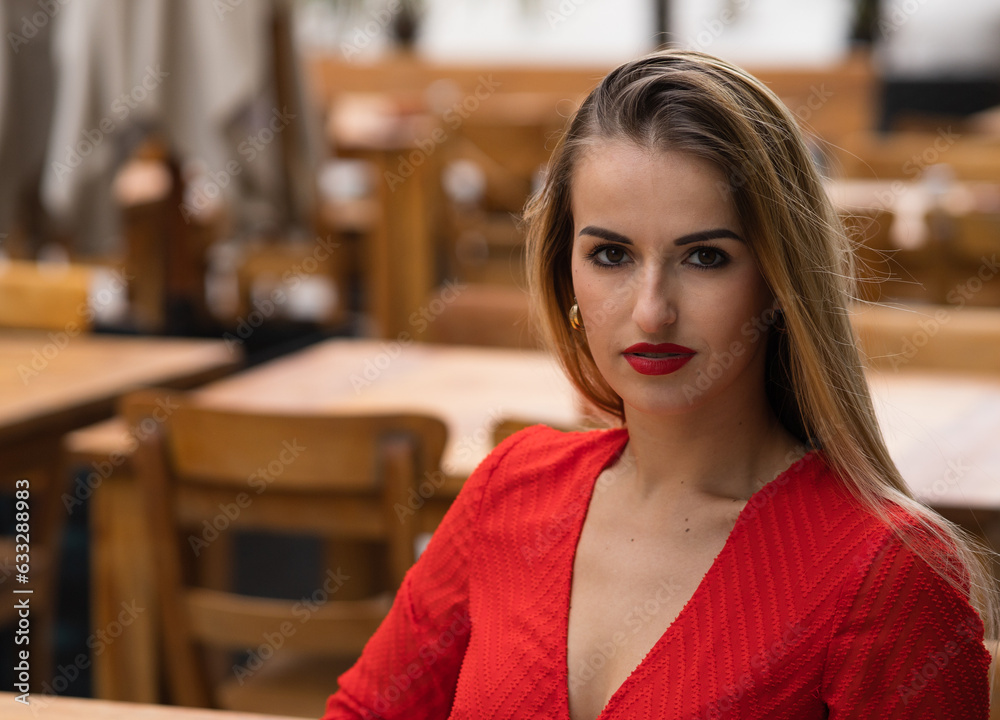 beautiful girl in a red dress at a table in a cafe beautiful girl in a red dress at a table in a cafe