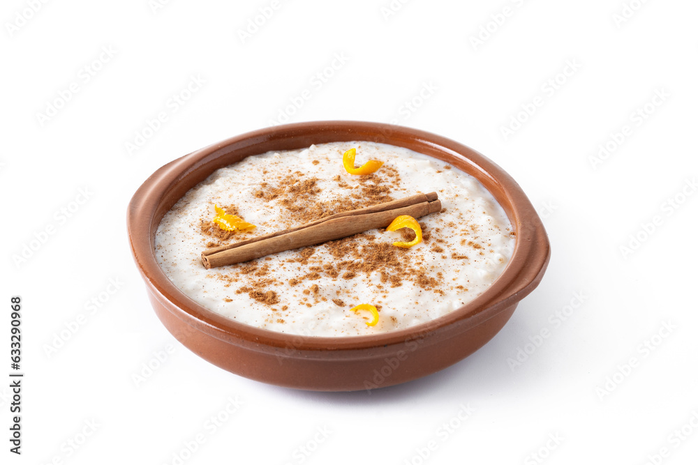 Arroz con leche. Rice pudding with cinnamon in clay bowl isolated on white background Arroz con leche. Rice pudding with cinnamon in clay bowl isolated on white background