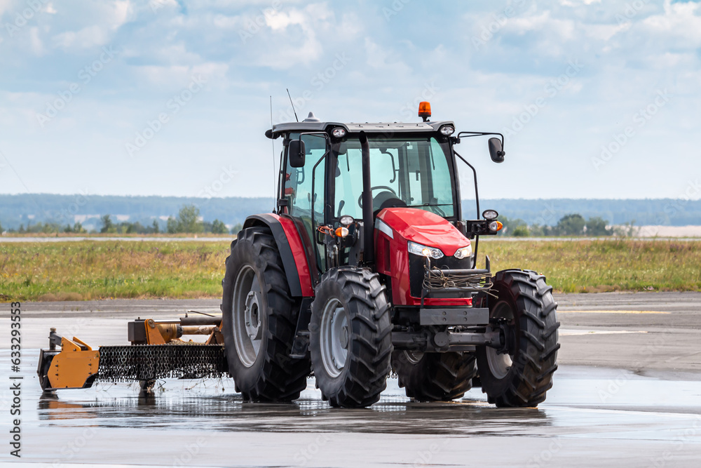 Wheel tractor with lawn mower on the road