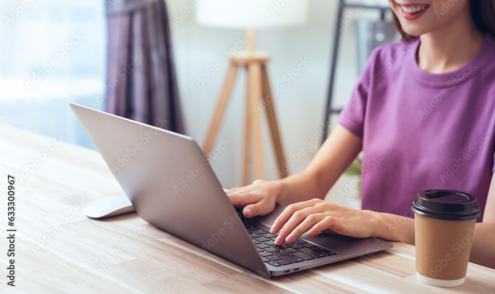 Woman using laptop and hand typing on the computer keyboard in the office. Woman using laptop and hand typing on the computer keyboard in the office.