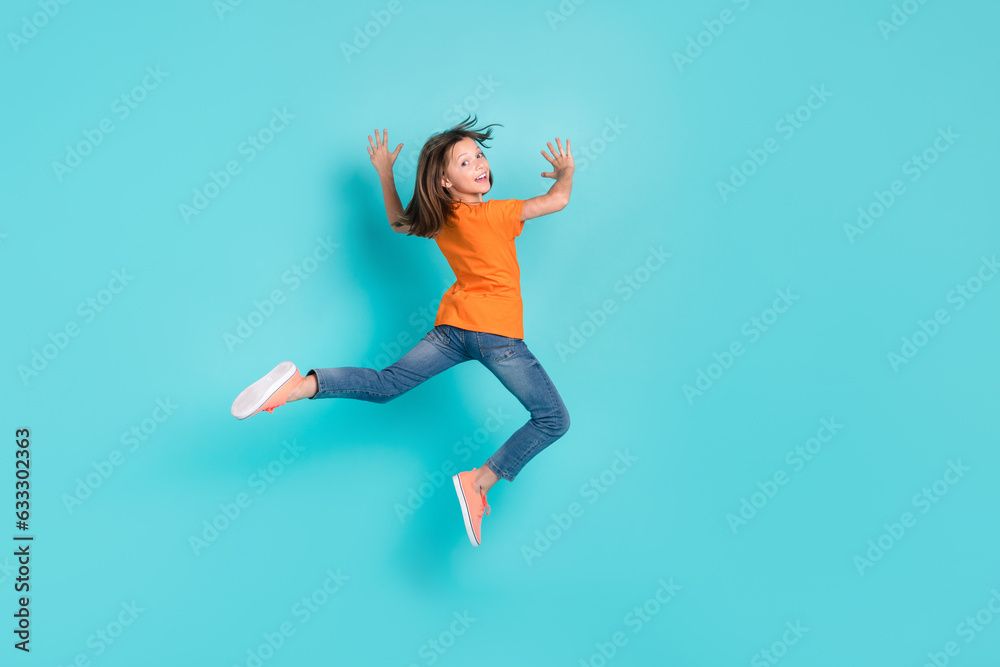 Back rear view photo of cheerful positive girl wear trendy comfort orange outfit good mood have fun isolated on cyan color background