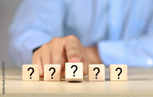 Question mark, Confused, Thinking, Brainstorming or Decision, Problem Solving, Finding Answer, Question. Marked words in wooden blocks on table top.	
