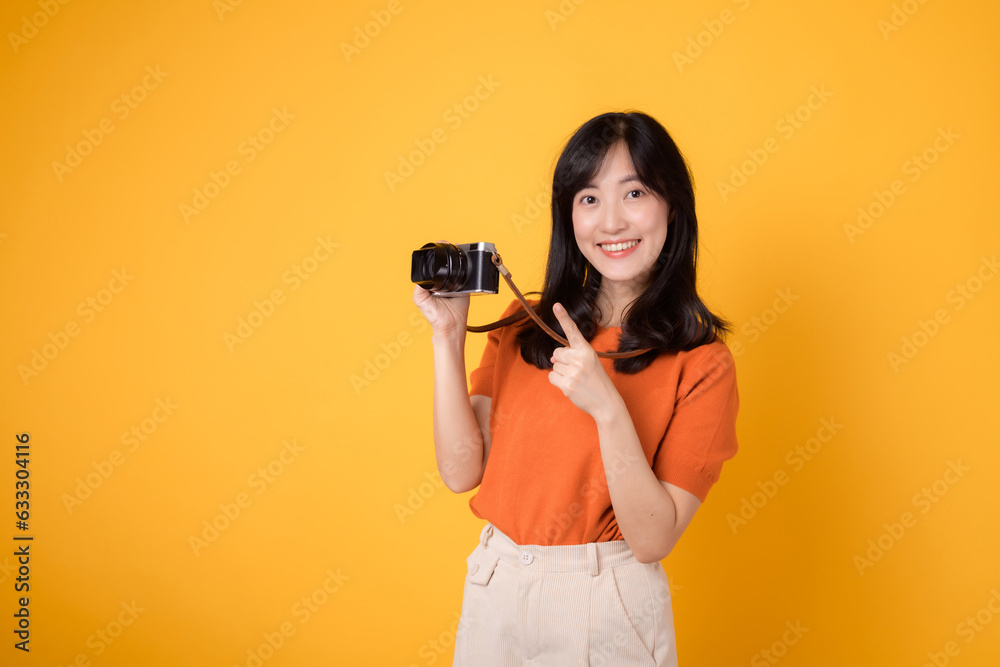 Vibrant woman with a camera isolated on yellow background, showing the adventure of exploring new places on her vacation. Vibrant woman with a camera isolated on yellow background, showing the adventure of exploring new places on her vacation.