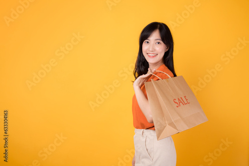 Smiling asian woman shopper with bags, enjoying a sale and adding new fashion finds to her collection. Fashionable retail therapy.