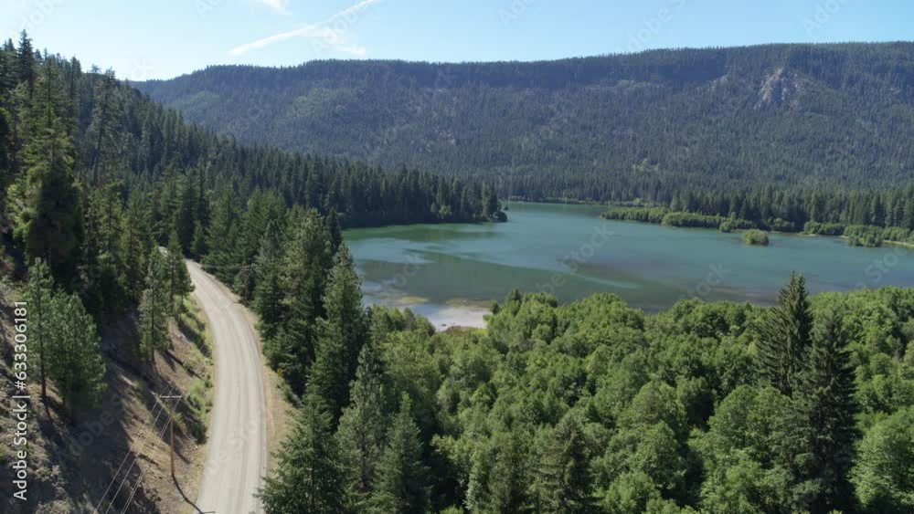 Aerial of dirt road next to Clear Lake in Gifford Pinchot National forest in Washington in summer Aerial of dirt road next to Clear Lake in Gifford Pinchot National forest in Washington in summer