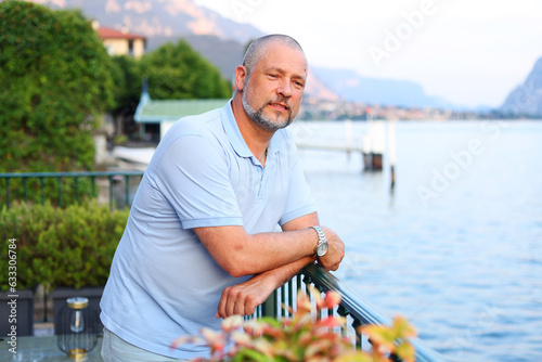 man standing on the Como lake and look on sunset. 