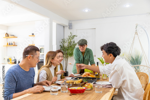Group of Cheerful Asian man and woman eating food and drinking wine celebration dinner party together at home. Happy people friends enjoy and fun celebrating reunion meeting holiday event vacation.