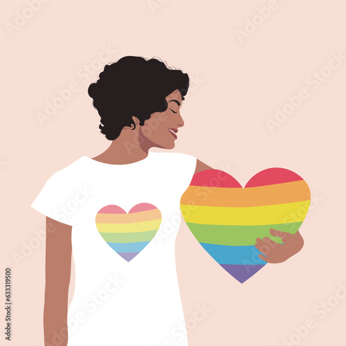 A girl embraces an LGBT rainbow heart. A girl in a white T-shirt holds a heart. The concept of a homosexual, a gay community, a tolerant LGBTQ society.