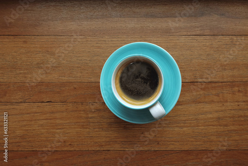 close up of a cup of coffee on wooden background 