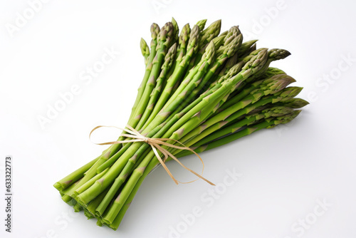 A bundle of fresh asparagus tied together with a white ribbon on a plain white background (ID: 633322773)