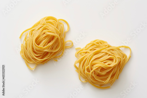 Fresh spaghetti, ready to be cooked, laid out on a white surface, italian pasta tagliatelle (ID: 633322921)