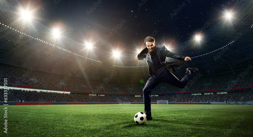 Emotional businessman hitting football ball on 3d arena with flashlights. Earning money during match. Concept of sport, fan, betting and finances, gambling, bookmaker