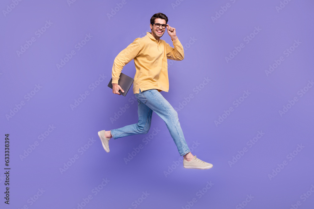 Full size body photo of run active leader guy professional it specialist working remote carry netbook isolated on violet color background