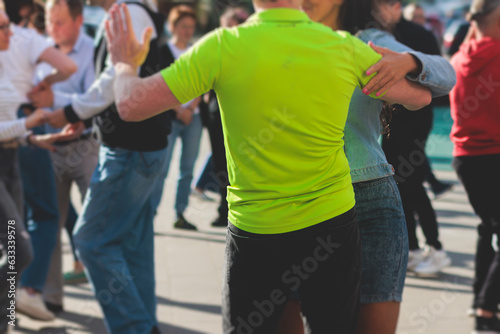 Couples dancing traditional latin argentinian dance milonga outdoor in the city streets, tango salsa bachata kizomba lesson, outdoors dance school class festival in a summer sunny day