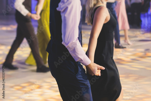 High school graduates dancing waltz and classical ball dance in dresses and suits on school prom graduation, classical ballroom dancers dancing, waltz, couples quadrille and polonaise