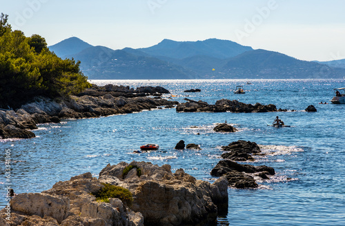 Rocky coast with woods and forest of Ile Saint Honorat island of Abbaye de Lerins monastery offshore Cannes at French Riviera in France photo