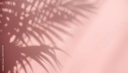 Blurred shadow from palm leaves on the pink wall. Abstract background for product presentation.