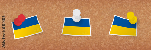 Ukraine flag pinned in cork board, three versions of Ukraine flag.