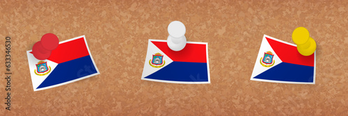 Sint Maarten flag pinned in cork board, three versions of Sint Maarten flag.