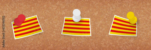 Catalonia flag pinned in cork board, three versions of Catalonia flag.