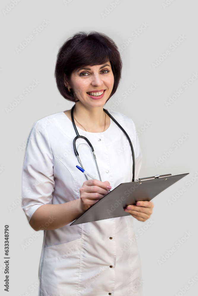 Girl doctor brunette writes down information on paper, white background. Girl doctor brunette writes down information on paper, white background.