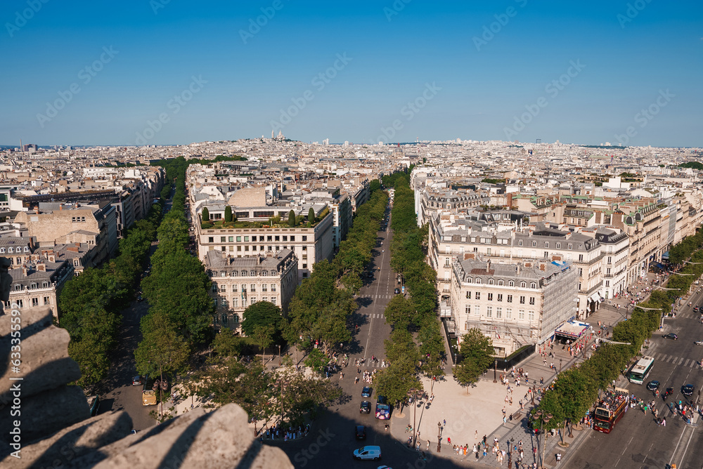 Fototapeta premium Oblique view of Paris cityscape from the Eiffel Tower on a sunny day with blue sky.
