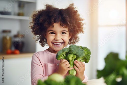 Child holding broccoli in front of her eyes with smiling face at kitchen. AI generated