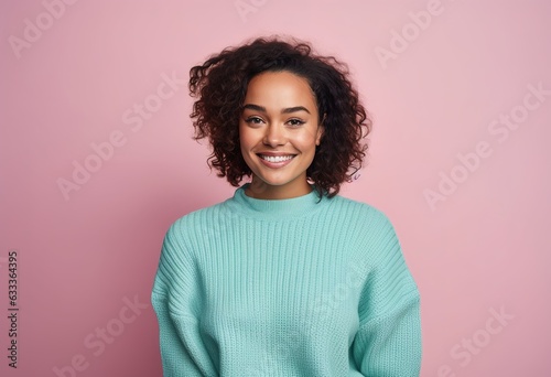 Happy Woman with a turquoise sweater on a pink background