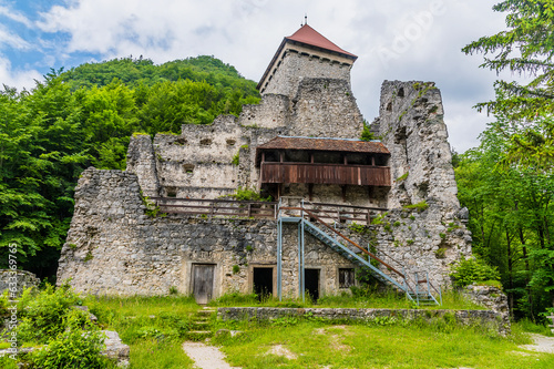 A view towards the keep and tower in the ruins of the Stone Castle on the outskirts of the town of Begunje na Gorenjskem, Slovenia in summertime photo