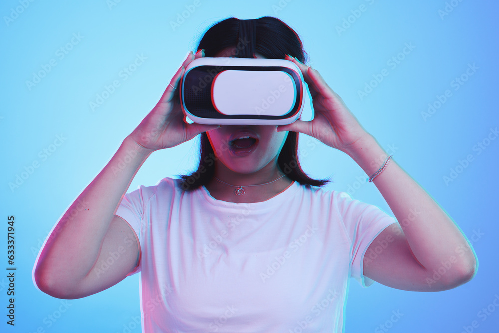 Woman, VR technology and surprise in studio for user experience, digital world and future multimedia game on blue background. Virtual reality glasses, metaverse and wow for innovation of UX gaming Woman, VR technology and surprise in studio for user experience, digital world and future multimedia game on blue background. Virtual reality glasses, metaverse and wow for innovation of UX gaming
