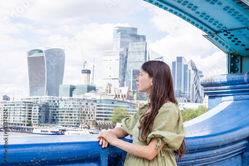 London, United Kingdom, 21 june 2023: Woman portrait The City of London skyline Bank Canary Wharf, central London's leading financial districts famous skyscrapers River Thames  futuristic buildings