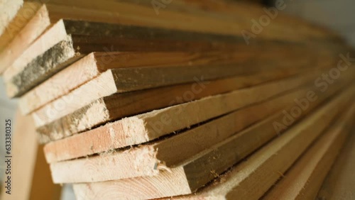 Folded pine boards close-up, even end cut. Smooth camera movement photo