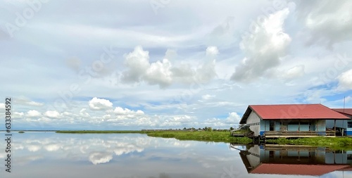Traditional house by a lake or swamp area © Dian