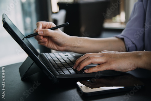 Wallpaper Mural Asian Business woman using calculator and laptop for doing math finance on an office desk, tax, report, accounting, statistics, and analytical research concept Torontodigital.ca