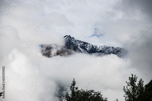Dark and Dramatic Himalaya Mountain in the Clouds Hidden by Fog in Nepal