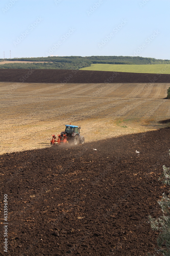 Obraz premium A tractor plowing a field