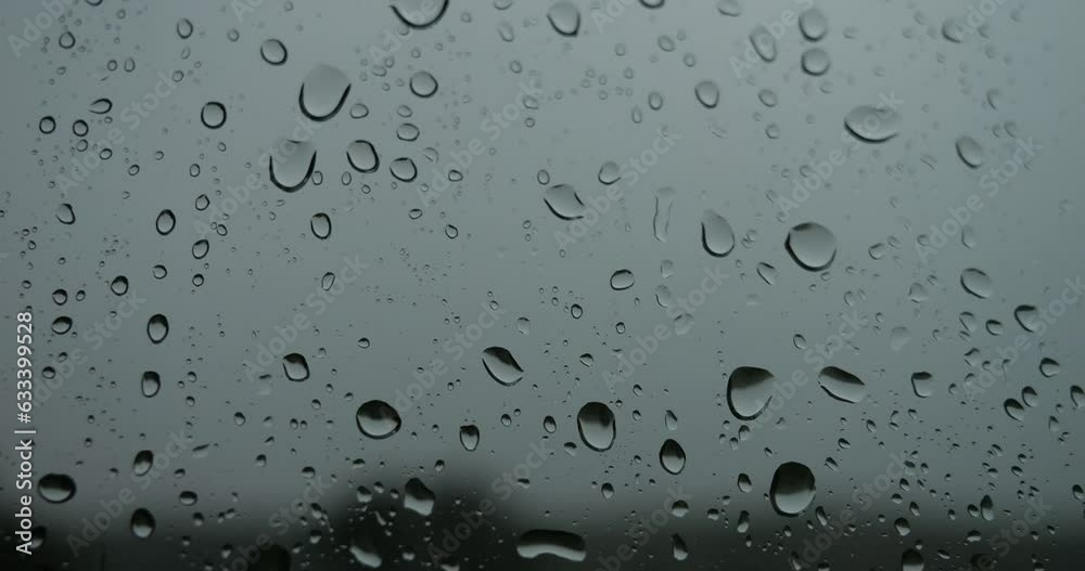 Rain outside the window. Raindrops run down the glass. Texture with drops of water. Bad weather.