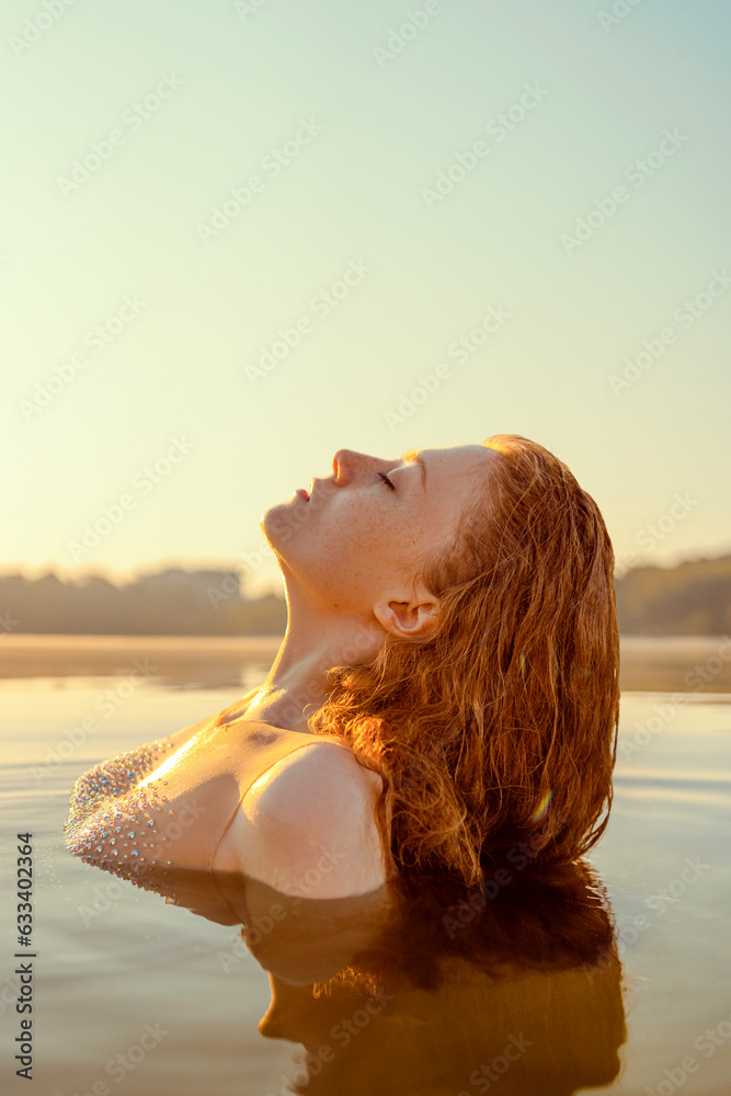 Beautiful redhead woman as mermaid with giant seashell